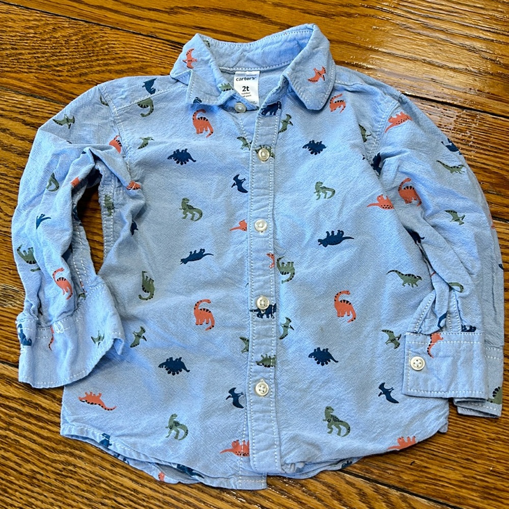 Carter’s blue boys button up shirt. Blue with dinosaur print. Size 2T.